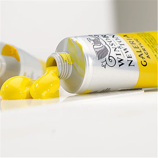 A tube of yellow Galeria Acrylic paint with the lid off, squeezed